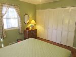 Green bedroom with queen bed